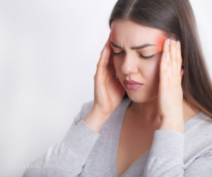 A woman holding her head in pain