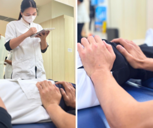 患者役のスタッフがベッドに仰向きに寝ている。その骨盤の横あたりをセラピストが両手で抑えている。